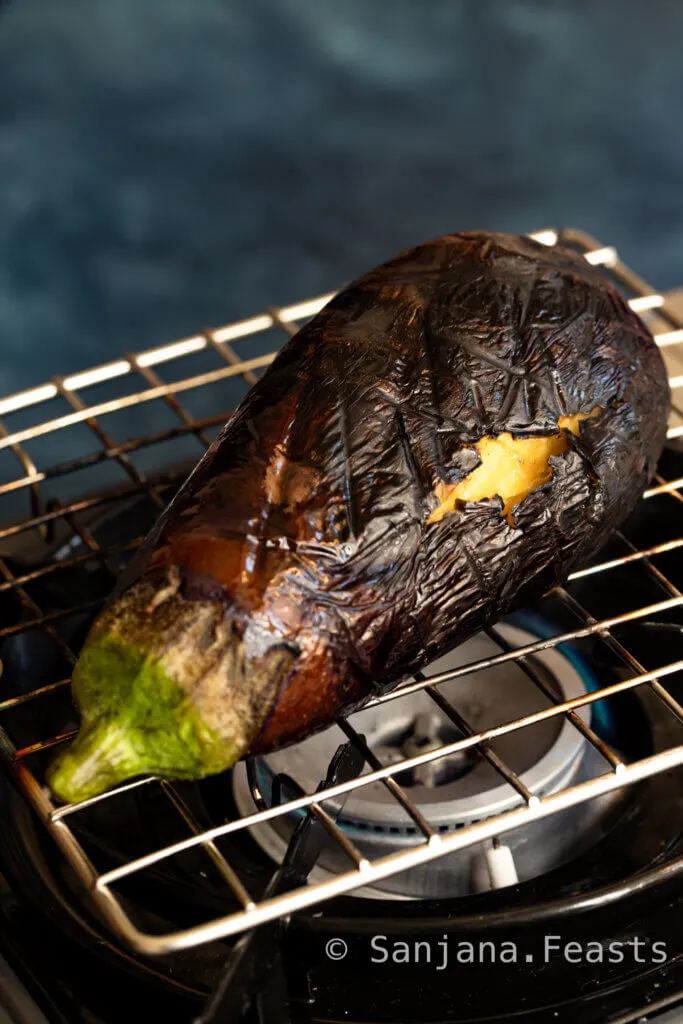 burnt aubergine over gas flame